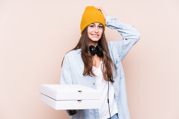 Young caucasian woman holding pizzas isolated being shocked, she has remembered important meeting.