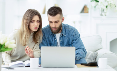 Confident couple trying to manage domestic finances