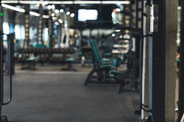 Dark empty gym interior with training equipment