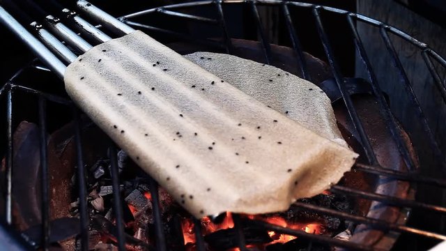 Street food.Fast food.Asian cuisine. White rice pancake cooked on street market