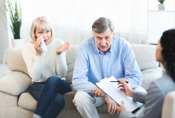 Senior couple in therapy working out problems with counselor