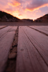 Sunset in Cala Benirras Ibiza Spain. View from wooden beach boards