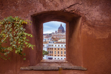 View of Saint Peter's Cathedral through a stone window of Castel Sant'Angelo.Rome, Italy