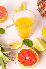 freshly squeezed juice in a glass and fruits