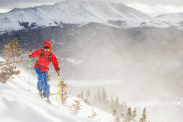 One man ski touring on a windy winter morning outside of Breckenridge, Colorado.