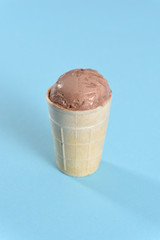 Ice cream in a waffle cup on a turquoise background