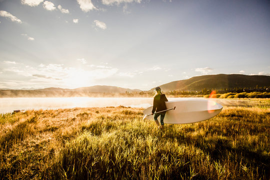 A female paddlboarder on Lake Dillon in Summit County, Colorado in the early morning.
