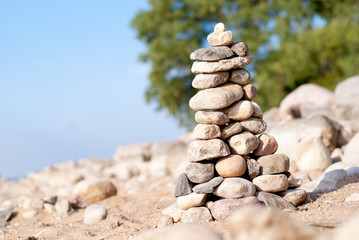 Fototapeta na wymiar Pile of pebbles in the balance on the seacoast