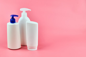 Skin care lotions on pink background