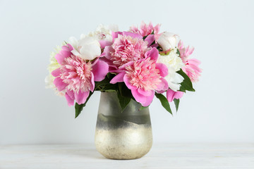 Beautiful peony flowers closeup over textured background with a lot of copy space for text. International women's mother's valentine's first spring day. Close up, top view, backdrop, flat lay.