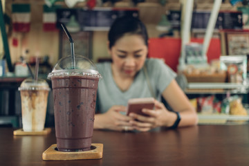Woman is using smartphone in the coffee cafe.