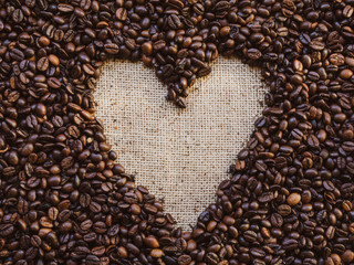 Top view of roasted coffee beans with heart. Coffee lovers