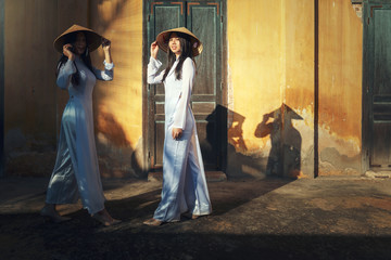 Vietnam women wearing Ao Dai Vietnamese traditional dress in the ancient house