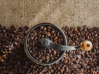 Top view of a coffee grinder with roasted coffee beans