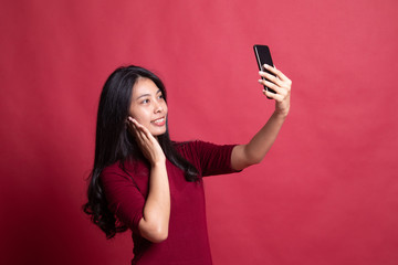 Naklejka premium Young Asian woman selfie with mobile phone.