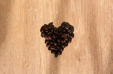 coffee bean heart on wood surface - Powered by Adobe