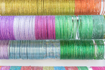 Indian wrist bracelets stacked in piles on display in Little India Singapore