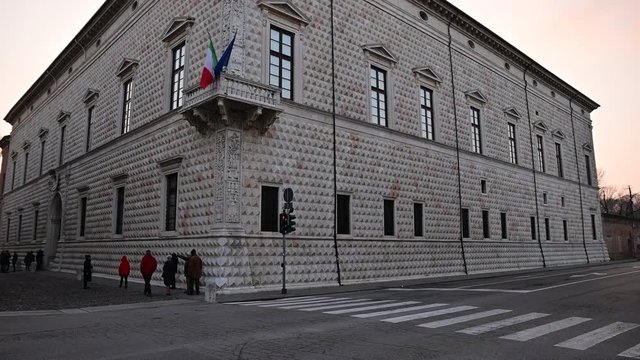 Ferrara, Italy.December 2019. Tilt footage on the building of Diamonds, so called because of its particular facade characterized by diamond-shaped ashlar. Passage of cars and people.