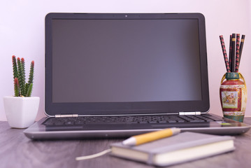 notebook on the table with vase and cactus, white