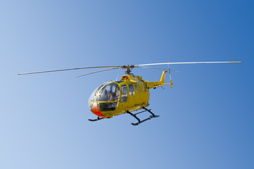 Flying yellow rescue helicopter