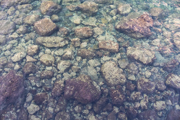 stone bottom under the extremely clear water of the sea