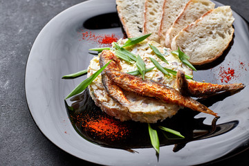 Forshmak on a black plate