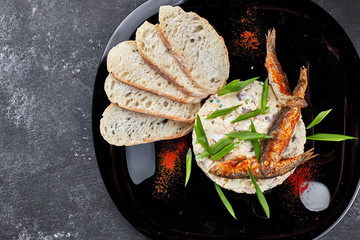 Forshmak on a black plate