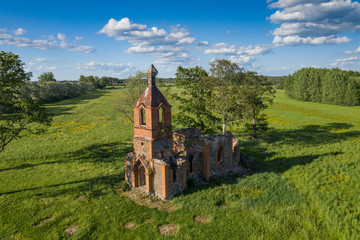 Orthodox Church and nature. Green garden and architecture. Under the blue sky a house which is surrounded by a beautiful natural environment. Trees, bushes and building - Estonia, Europe.