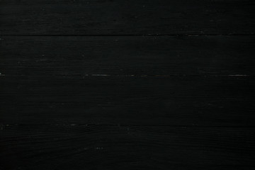Naklejka premium The structure of old, shabby black boards arranged horizontally.