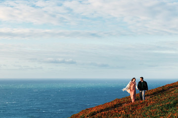 a romantic walk of a couple in the love of the ocean shore