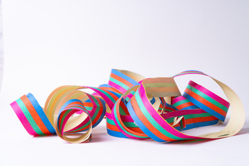A paper streamer laying on white background - close up