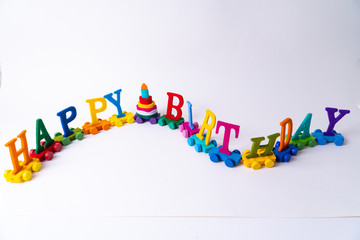 A train with the word "Happy Birthday" and a birthday cake on white background