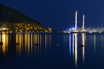 Fototapeta na wymiar Yachts at the pier and beach in night illumination, Marmaris, Turkey