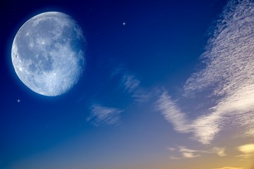 Starry sky with half moon in scenic cloudscape . 