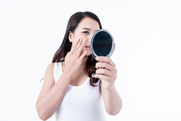 Blurred soft images of Asian young pretty woman looking in the mirror And there is a concern about acne granules that appear on the face On white background, This picture focuses on mirror