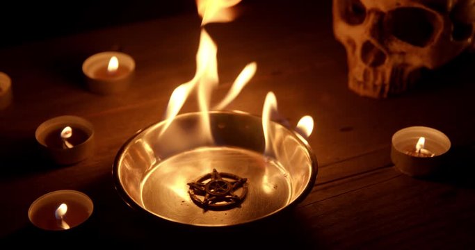 Burning pentacle on altar closeup footage