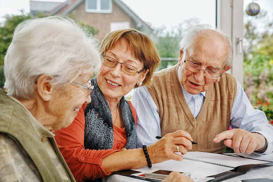 Elderly Couple and Dughter Making Plans