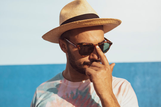Picture of hipster man standing isolated over blue background