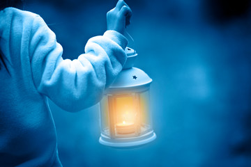 Lantern in hand illuminates the road travel and discoveries, classic blue color