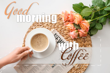 Female hand with cup of coffee, rose flowers and text GOOD MORNING WITH COFFEE on white background....