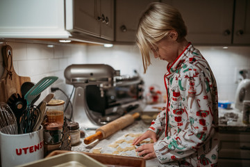 Girl making cookies in holiday pajamas