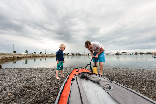 Father and son preparing a kayak