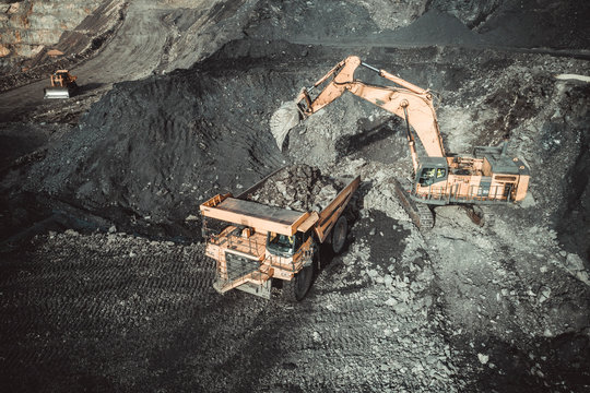Excavator Loading Coal Truck from Aerial View
