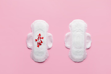 Menstrual pads with red beads on color background. Menstruation concept
