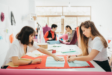Fashion designers working in the design studio