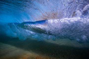 Crystal clear wave twist shot from below the surface in Maui, Hawaii
