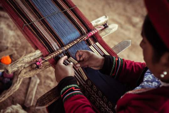 High angle view of woman weaving alpaca wool on loom