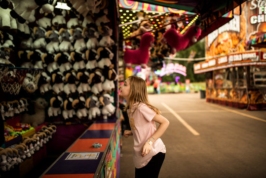 GIRL PLAYING GAMES AT THE CARNIVAL