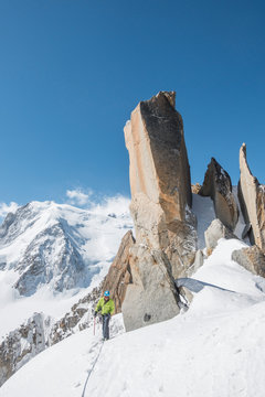 Alpinist climbs easy terrain on the Cosmiques Ridge in sunny weather