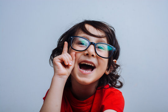Smiling Little boy raising his hand